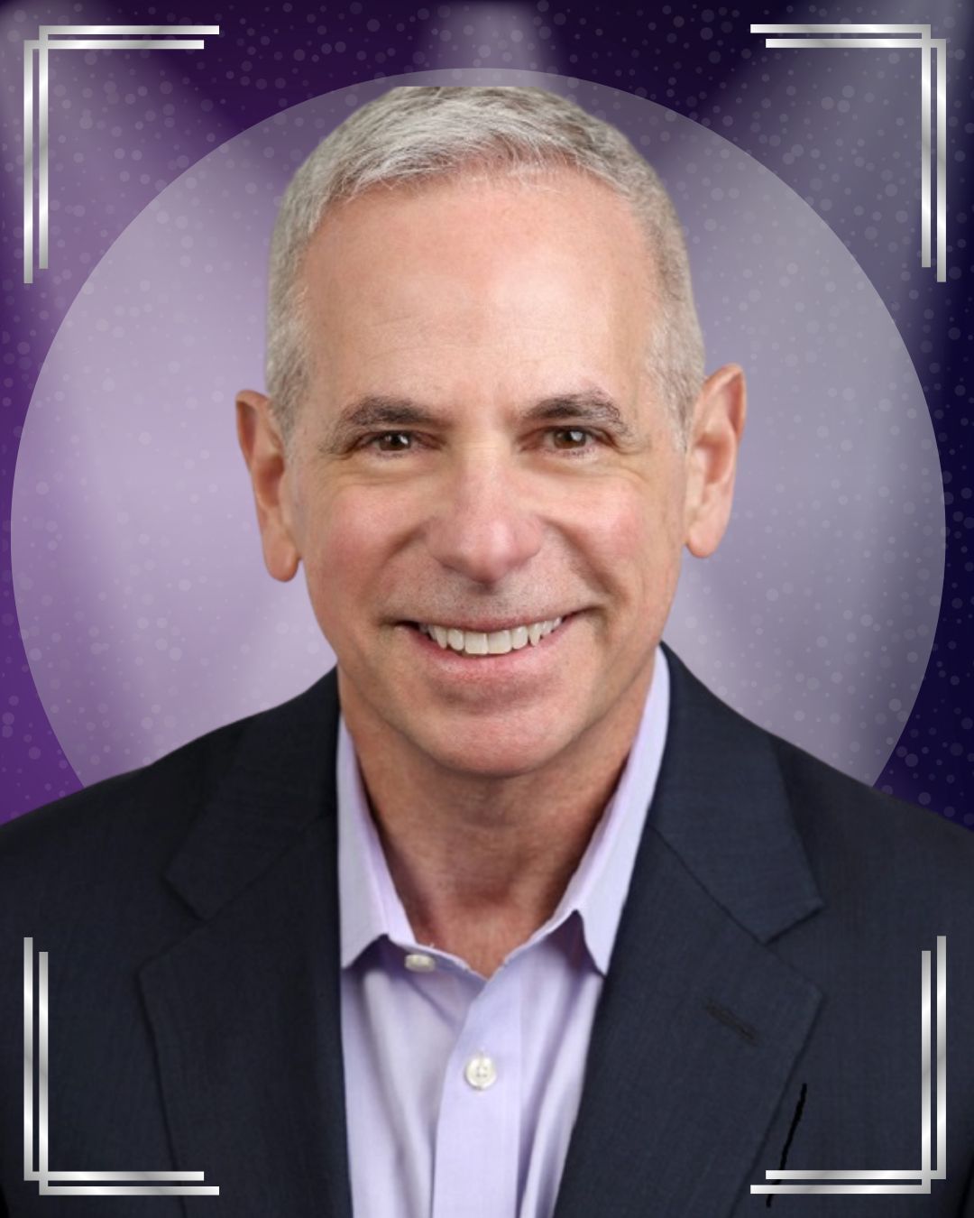 Portrait of a middle-aged man with short gray hair, wearing a dark suit jacket and a light dress shirt, smiling against a purple, softly illuminated background with decorative square border accents.