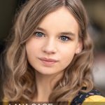 lana-sage-headshot-1 Girl with blonde hair wearing yellow sweater