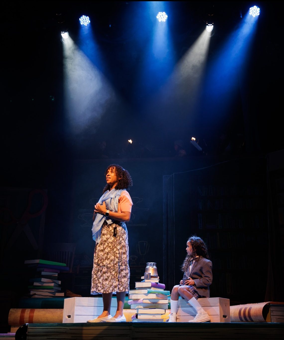 Matilda2 10/18/22 -- Boston, MA Kira Troilo as Miss Honey, left, and Sky Fuller as Matilda rehearse for Roald Dahl's Matilda The Musical at the Wheelock Family Theater on Oct 18. The show runs at the theater from October 21 – November 20. Photo by Jacob Chang-Rascle