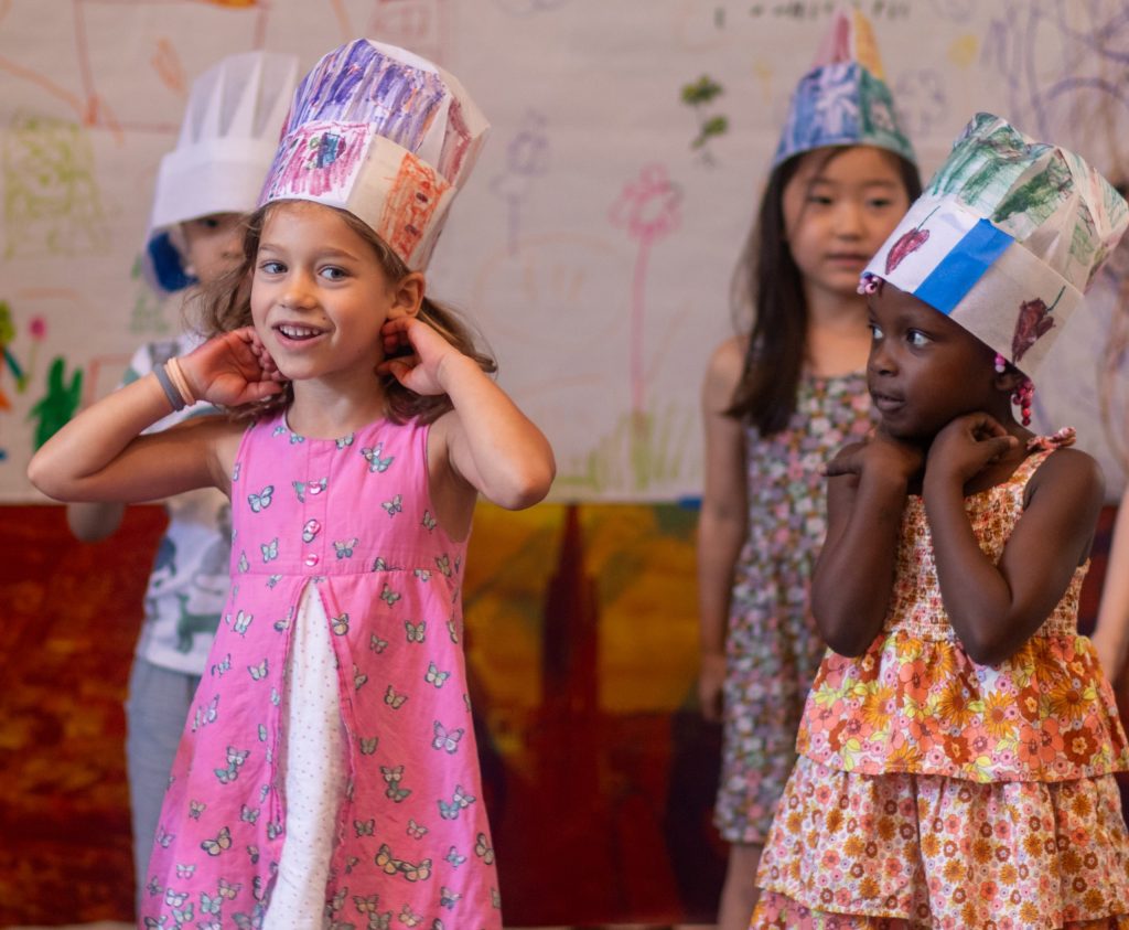 Students wear colorful paper hats. Students wear colorful paper hats.