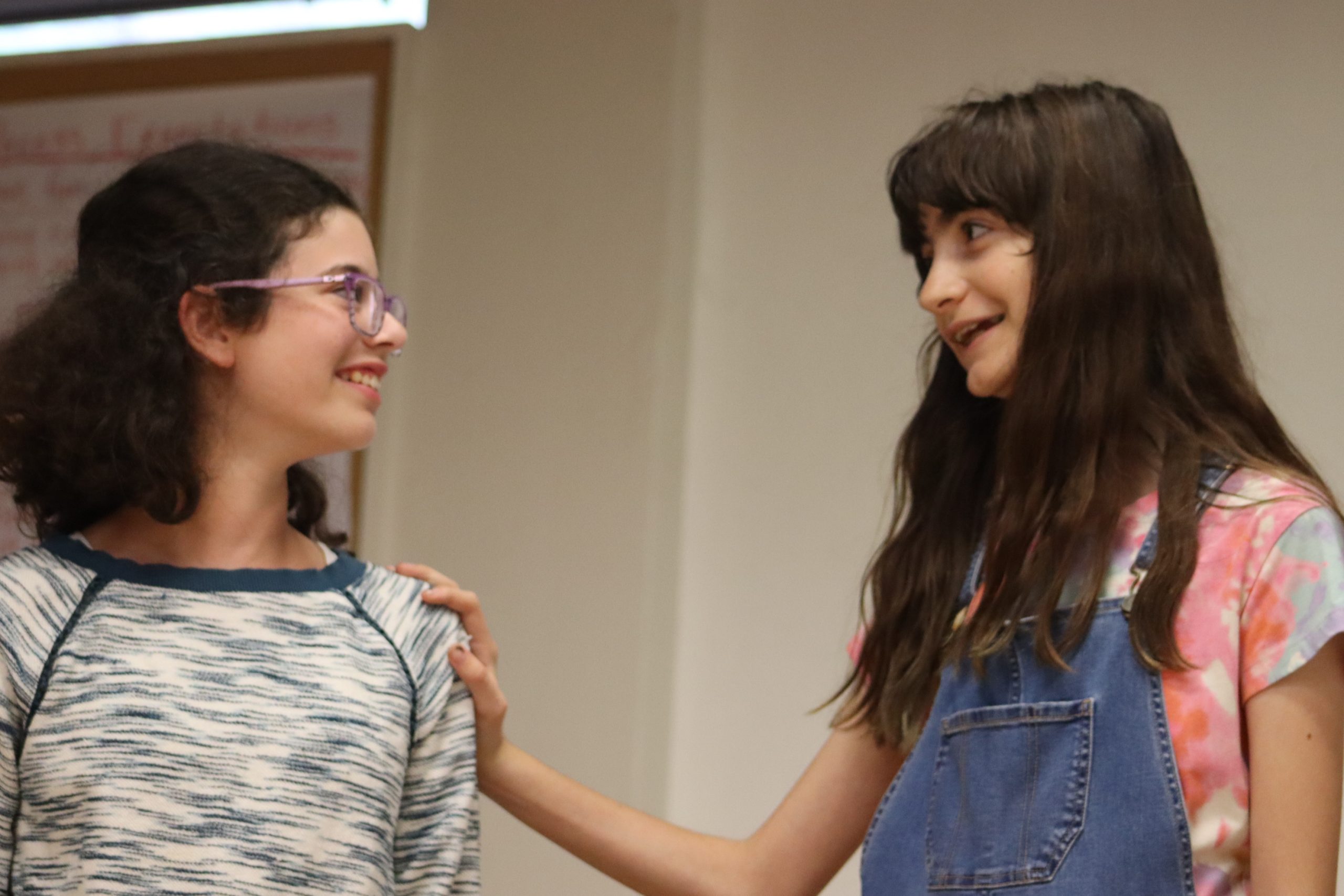 summer-2026-landing-image-2 Two students share a smile with one another.